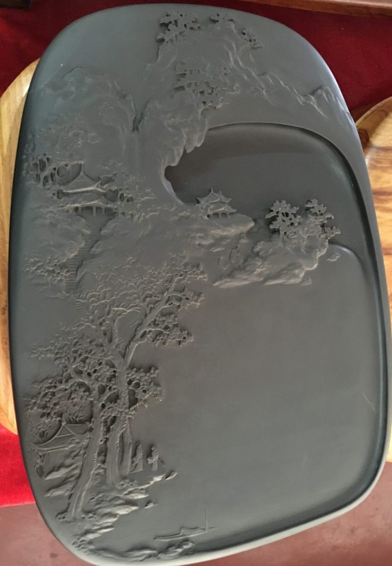 inkstone carved with mountain scene and temples